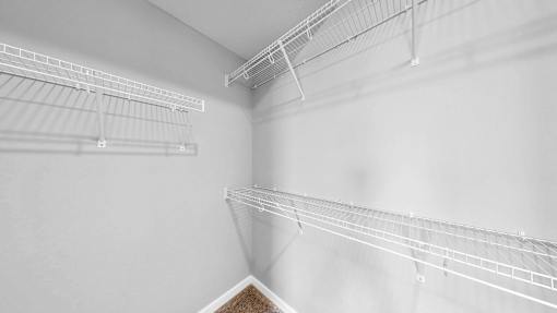 Empty white shelves in a room.