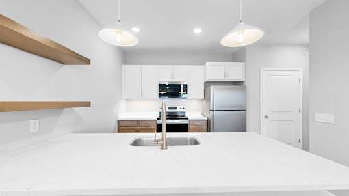 A modern kitchen with a large island in the center.