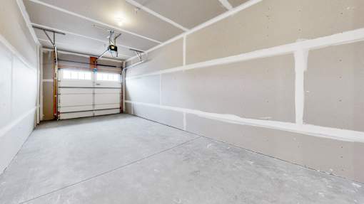 A large empty room with a door on the left side.