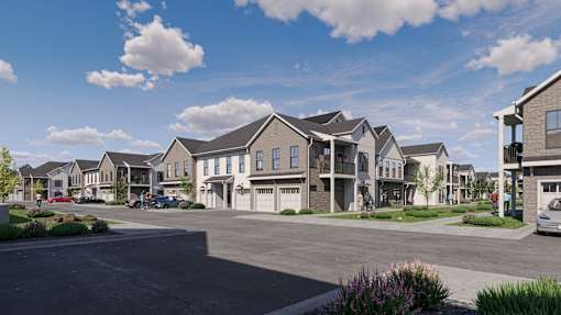 A row of houses with a car parked in front of the first house.