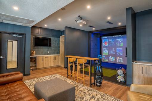 A modern living room with a leather couch and a television.
