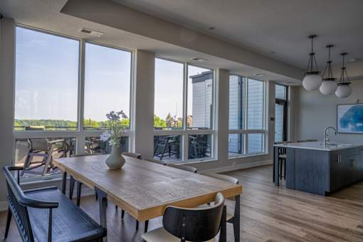A dining room with a wooden table and chairs.