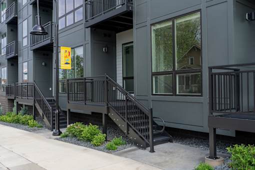 A building with a yellow sign on the balcony.