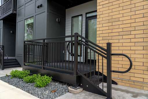 A black metal railing on a brick building.