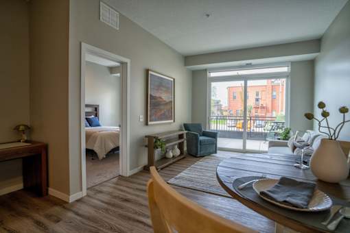 A living room with a bedroom in the background.