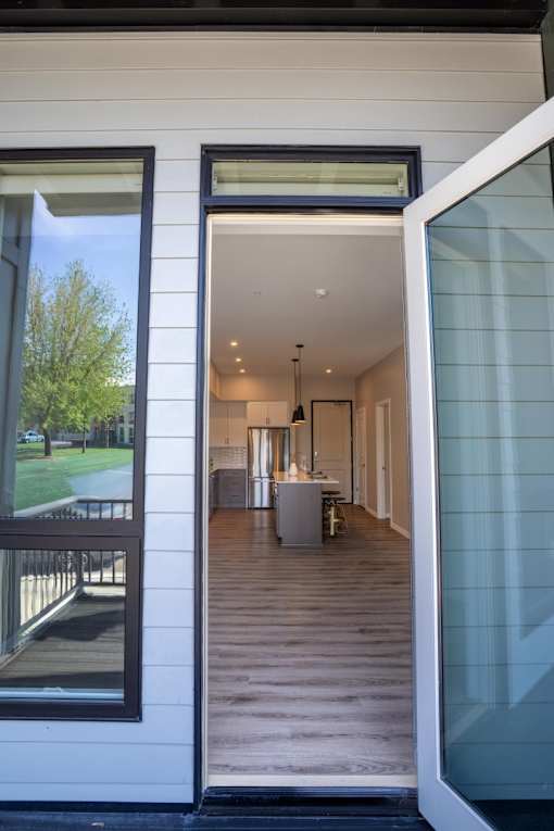 A modern house with a glass door entrance.