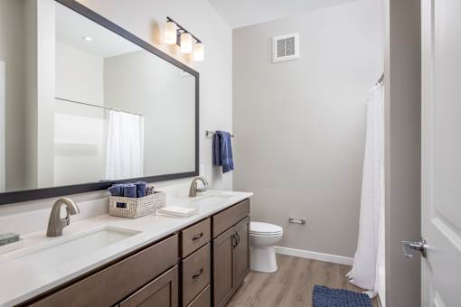 A bathroom with a white toilet and a white sink.