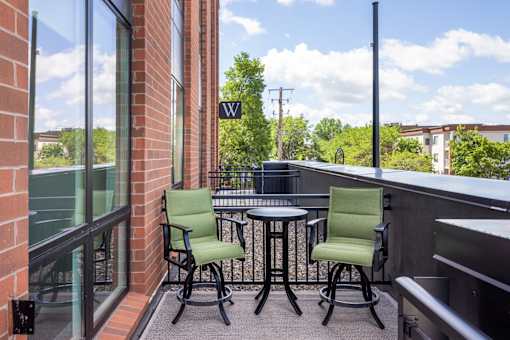 A patio with a table and two chairs.