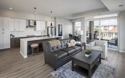 A modern living room with a grey sofa and a wooden coffee table.