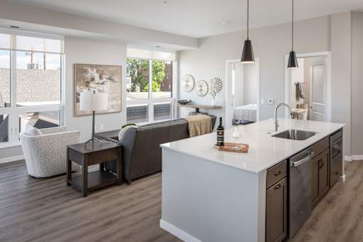 A modern kitchen with a large island and a view of the backyard.