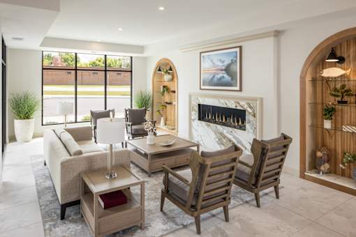 A living room with a fireplace and a painting on the wall.