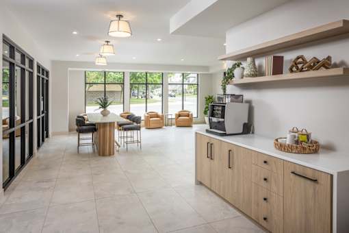 A kitchen with a table and chairs in the middle of the room.