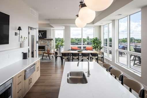A modern kitchen with a large island and a dining table.