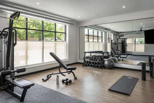 A well-equipped home gym with a variety of exercise equipment.