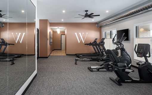 A gym with treadmills and exercise bikes.