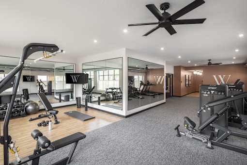 A spacious home gym with a variety of equipment.