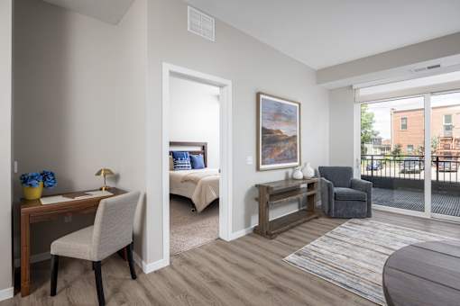 A room with a bed, desk, and chair.