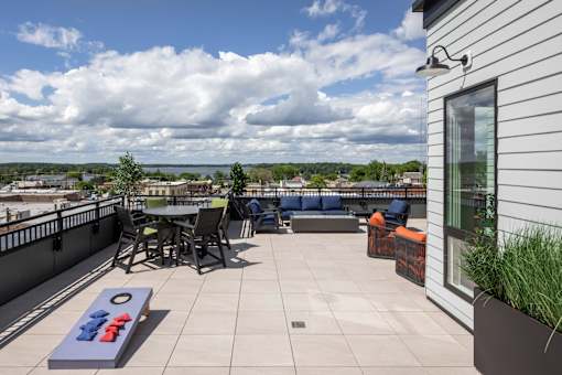 A patio with a table and chairs overlooking a town.