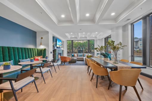 a lounge area with tables and chairs and a fireplace