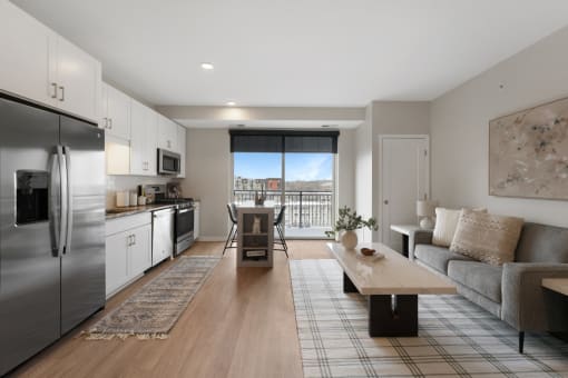 a living room with a couch and a table and a refrigerator
