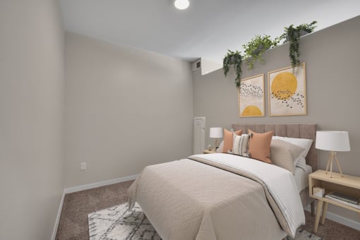 a bedroom with grey walls and a bed with a white comforter