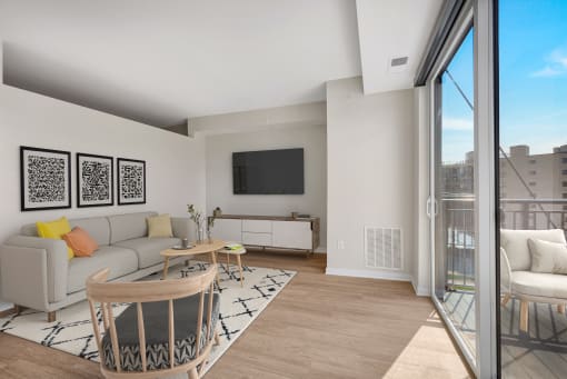 a living room with white walls and a sliding glass door that leads to a balcony