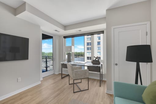 a bedroom with a desk and chair in a 555 waverly unit