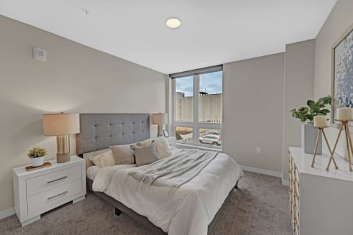 a bedroom with a large bed and a window