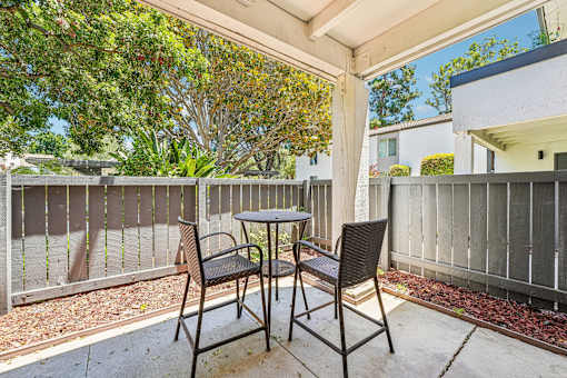 A patio with a table and two chairs.