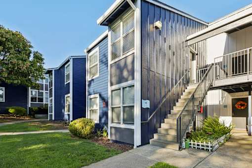 A blue house with a white door and a small garden in front. at Skyline Heights Apartments, Daly City