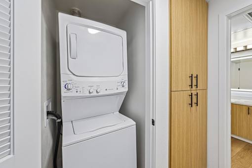 A white washing machine and dryer in a small laundry room.
