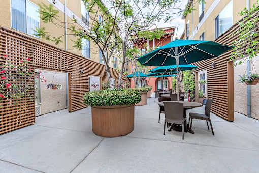 A Patio With Green Umbrella at Atrium Garden Apartment Homes, LLC, San Jose