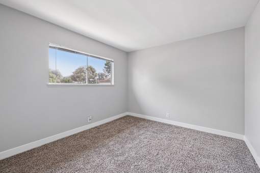 Spacious room with oversized window at Ocean Villas Apartments, Oxnard, California