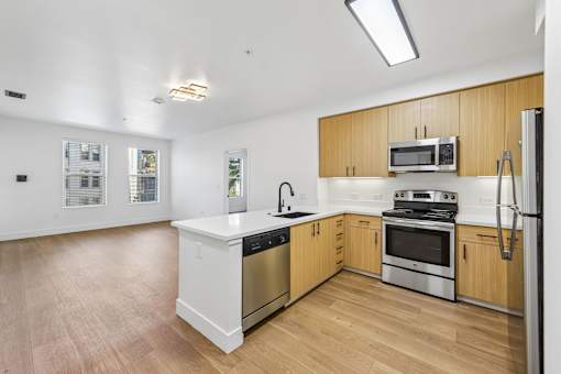 A kitchen with wooden cabinets and stainless steel appliances.
