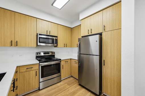 A kitchen with wooden cabinets and stainless steel appliances.