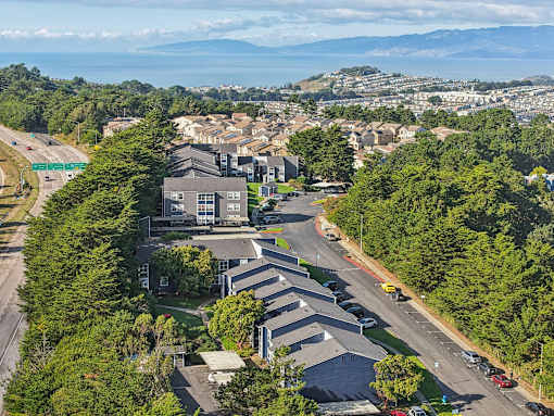 A bird's eye view of a residential area with houses and cars. at Skyline Heights Apartments, Daly City, CA