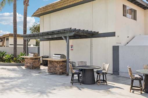 Outdoor patio with table and chairs at Ocean Villas Apartments, Oxnard, 93033