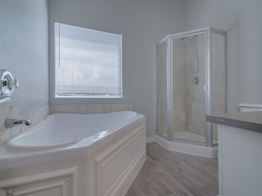 a white bathroom with a tub and a shower at Warner Center Townhomes, Canoga Park, 91303