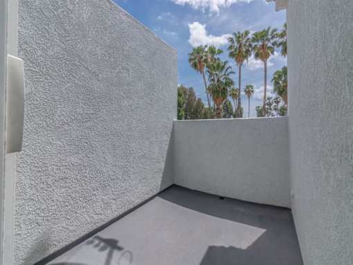the private balcony has views of the palm trees at Warner Center Townhomes, Canoga Park, CA