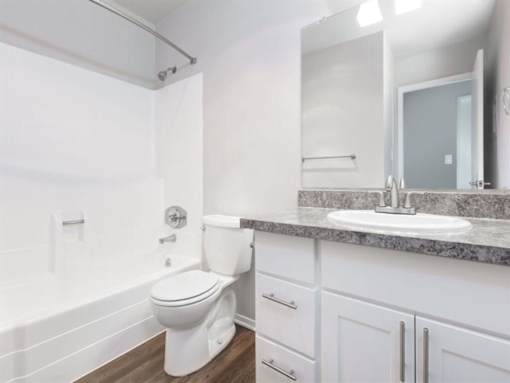 a white bathroom with a sink and a toilet at Skyline Heights Apartments, California, 94015