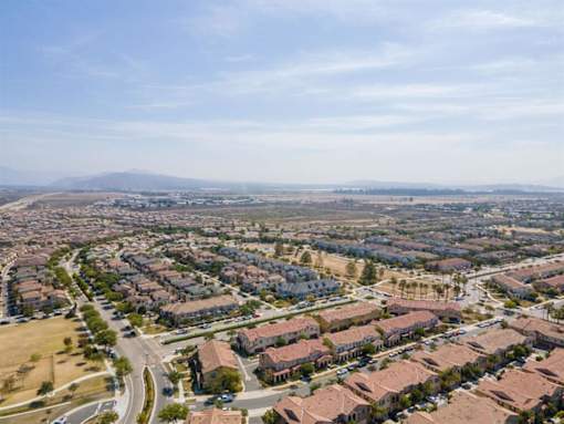 an aerial view of a city with houses and a highway at The Vines at Riverpark, LLC, California