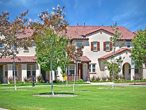 a large house with trees in front of it at The Vines at Riverpark, LLC, Oxnard, CA 93036
