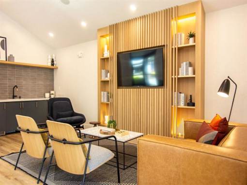 a living room with a couch and chairs and a television at Parc Medallion LLC, Union City California