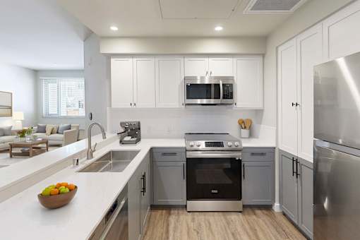 Modern kitchen with white cabinetry at 888 Fourth Street Apartments, LLC, Santa Rosa