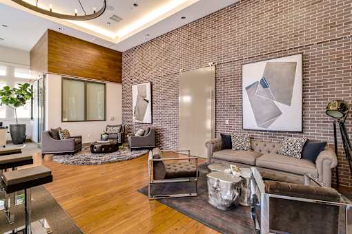 A modern living room with a grey couch and a large abstract painting on the wall. at Cirrus Redwood City Apartments, California, 94061