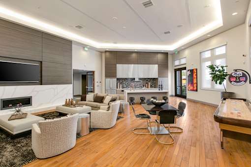 A modern living room with a fireplace and a dining table. at Cirrus Redwood City Apartments, Redwood City, 94061