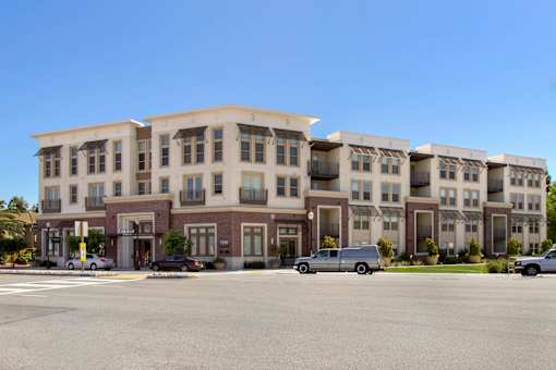 A large building with a parking lot in front of it. at Cirrus Redwood City Apartments, California, 94061