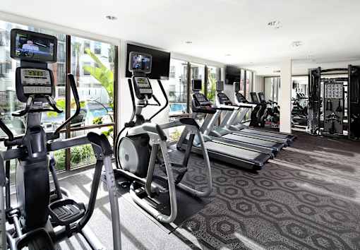 A gym with treadmills and elliptical machines. at Cirrus Redwood City Apartments, Redwood City, CA, 94061