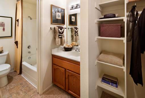 A bathroom with a toilet, sink, and a shower. at The Maddox Sunnyvale Apartments, Sunnyvale, California