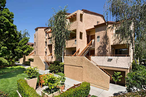 A beige building with a staircase in the middle of it. at The Maddox Sunnyvale Apartments, California, 94087